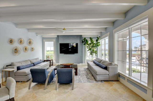 living room featuring beamed ceiling and a healthy amount of sunlight