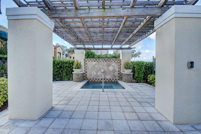 view of patio / terrace featuring a pergola and an in ground hot tub