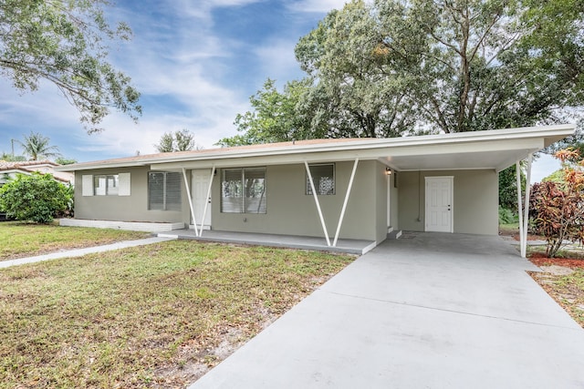 ranch-style home with a carport and a front lawn