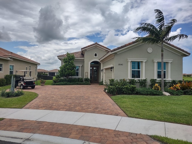 mediterranean / spanish-style home with a front yard