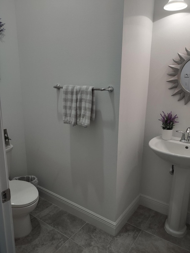 bathroom featuring tile patterned floors and toilet