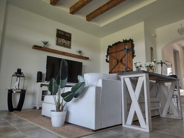 tiled living room with beamed ceiling