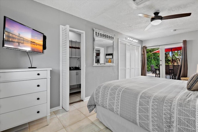 tiled bedroom with access to outside, ceiling fan, french doors, and a textured ceiling