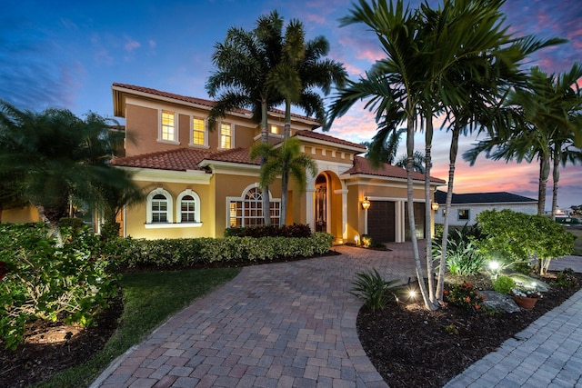 mediterranean / spanish-style home featuring a garage