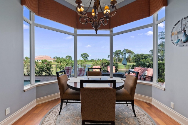 sunroom featuring a notable chandelier