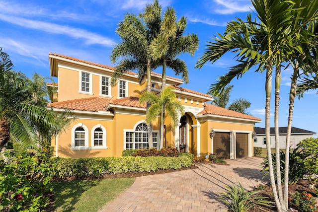 mediterranean / spanish house featuring a garage