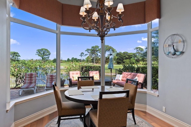 sunroom with a wealth of natural light and a chandelier