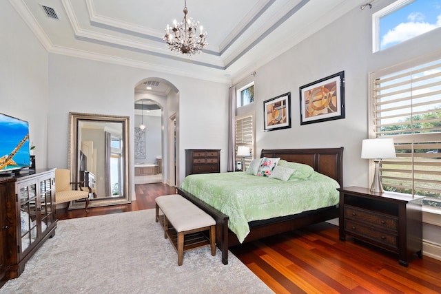 bedroom with multiple windows, ensuite bathroom, dark hardwood / wood-style flooring, and ornamental molding