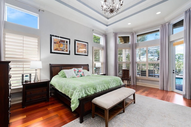 bedroom with multiple windows, crown molding, and wood-type flooring