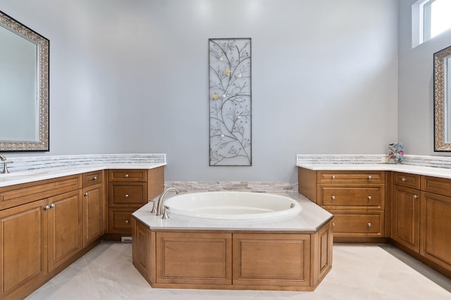 bathroom with tile patterned flooring, a washtub, and vanity