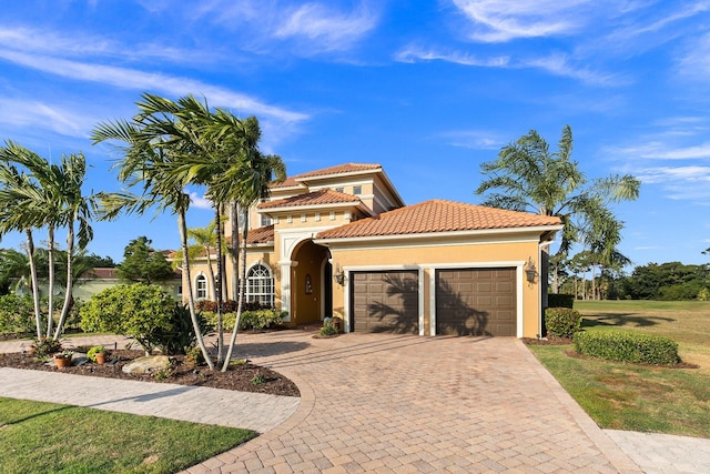 mediterranean / spanish-style house with a garage