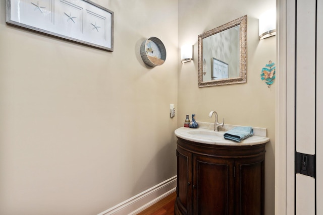 bathroom with hardwood / wood-style floors and vanity