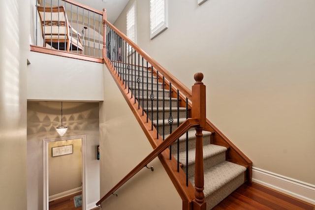 stairs with hardwood / wood-style flooring