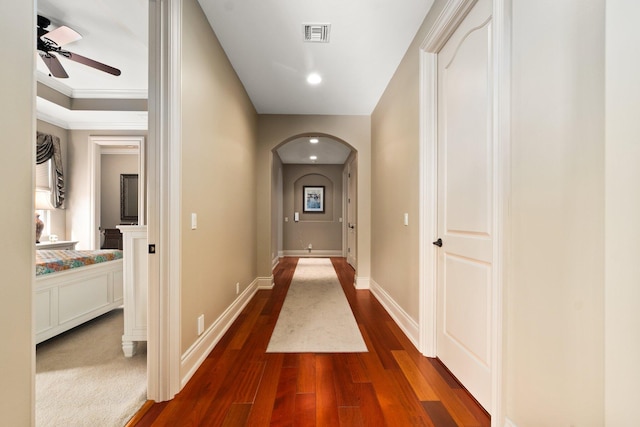 hall featuring crown molding and dark wood-type flooring