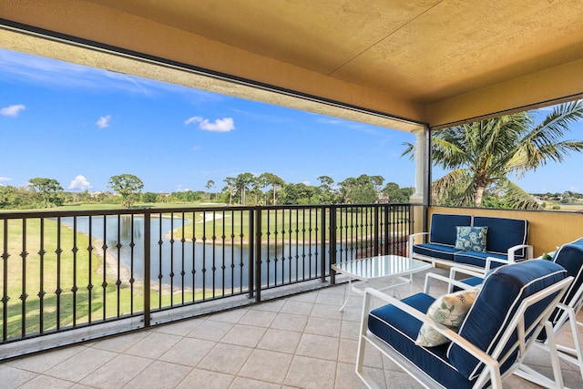 balcony featuring outdoor lounge area and a water view