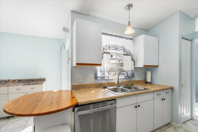 kitchen with stainless steel dishwasher, white cabinetry, sink, and hanging light fixtures