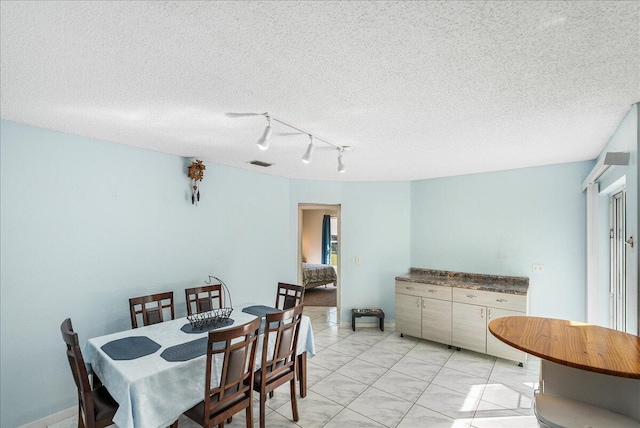 dining space with a textured ceiling