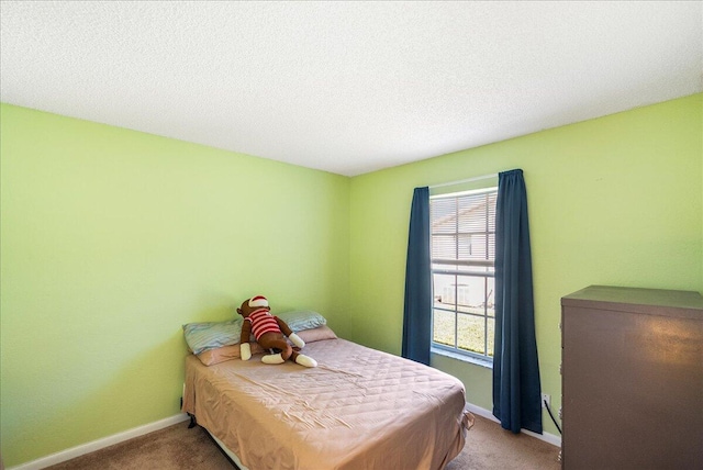 carpeted bedroom with a textured ceiling