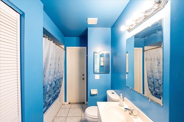 full bathroom with tile patterned flooring, toilet, shower / bath combo with shower curtain, and sink