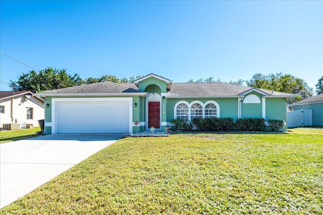 ranch-style home with a garage, central air condition unit, and a front yard