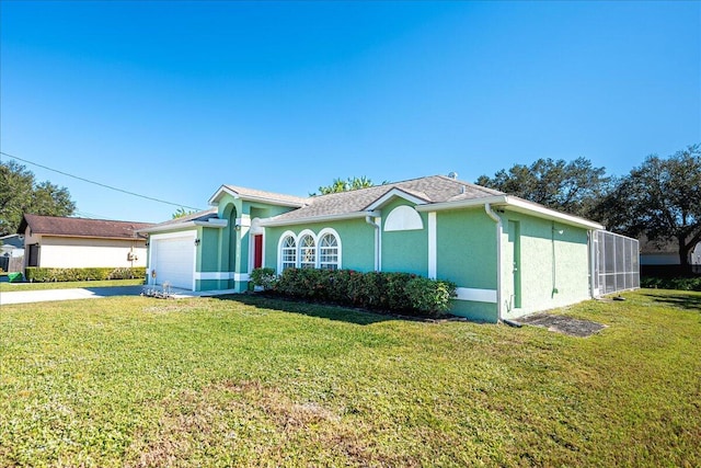 ranch-style house with a garage and a front lawn