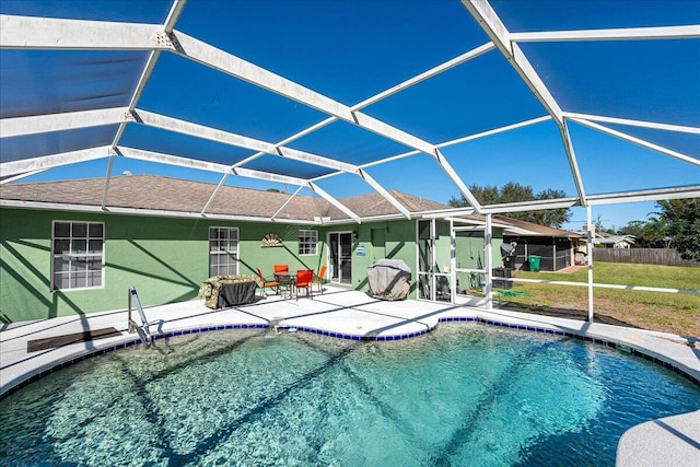 view of pool featuring glass enclosure and a patio area