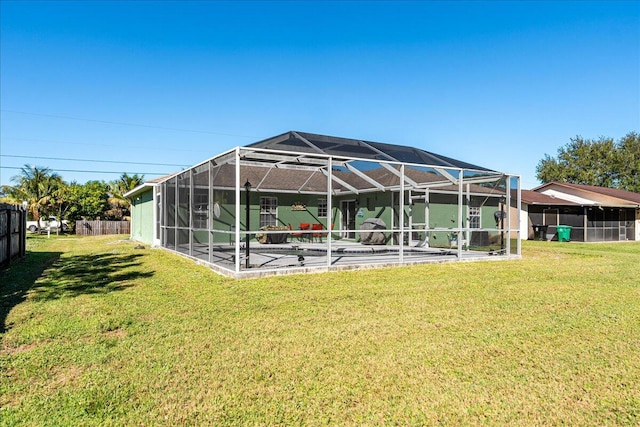 back of property with a lanai and a yard