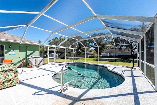 view of swimming pool with a yard, a lanai, and a patio area