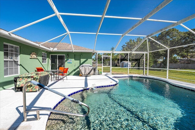 view of swimming pool with a lanai, a patio area, and a yard