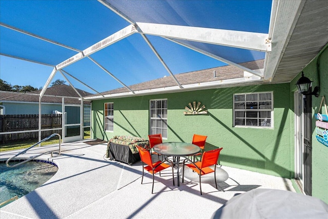 view of patio / terrace featuring glass enclosure and a pool