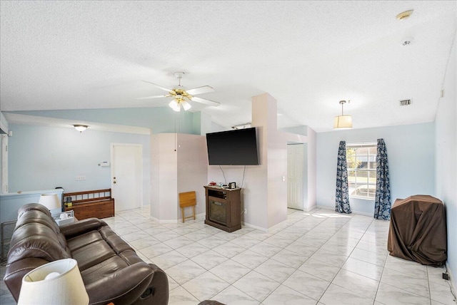 living room featuring a textured ceiling, vaulted ceiling, and ceiling fan