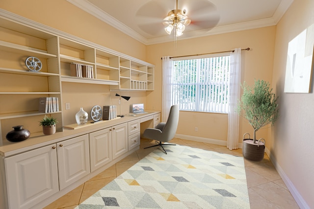 office area with ceiling fan, ornamental molding, built in desk, and light tile patterned floors