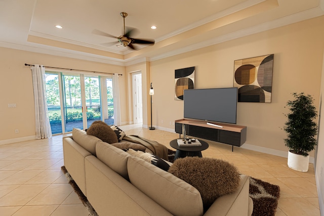 living room featuring crown molding, light tile patterned floors, and a tray ceiling