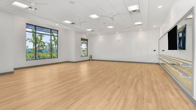 empty room featuring light hardwood / wood-style flooring and a drop ceiling