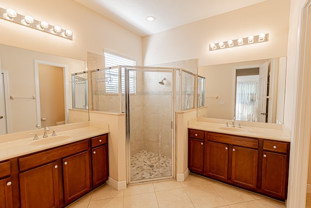 bathroom featuring an enclosed shower, vanity, tile patterned floors, and toilet