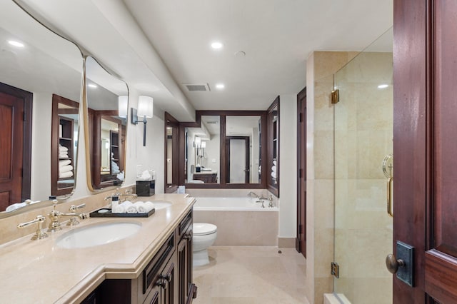 full bathroom featuring tile patterned floors, vanity, toilet, and independent shower and bath