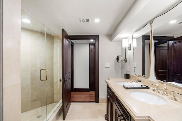 bathroom with tile patterned floors, vanity, and a shower with shower door