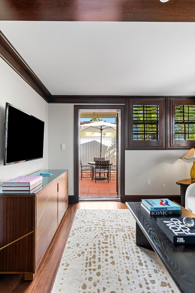 living room with light hardwood / wood-style floors and ornamental molding