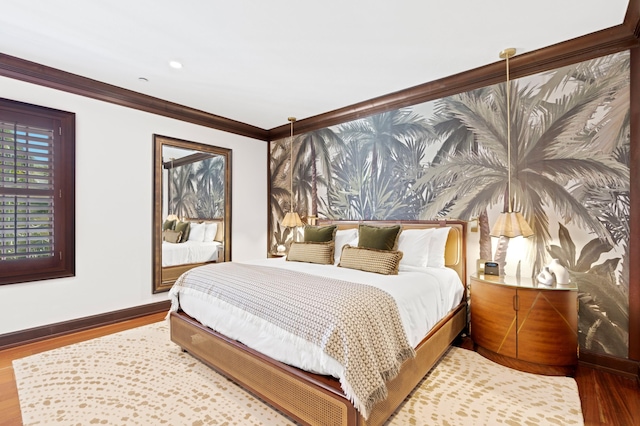 bedroom with hardwood / wood-style floors and crown molding