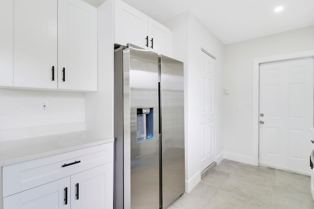 kitchen with white cabinets and stainless steel refrigerator with ice dispenser