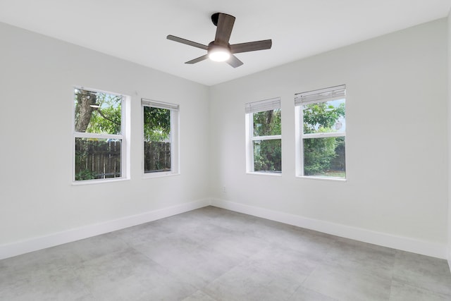 unfurnished room featuring ceiling fan and a healthy amount of sunlight