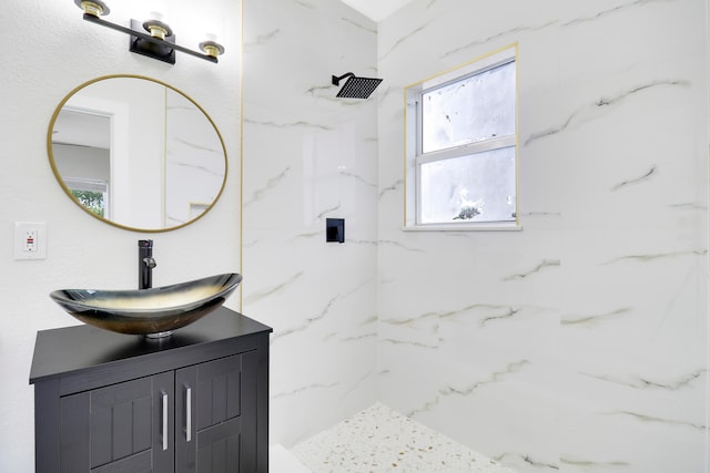 bathroom with vanity and tiled shower