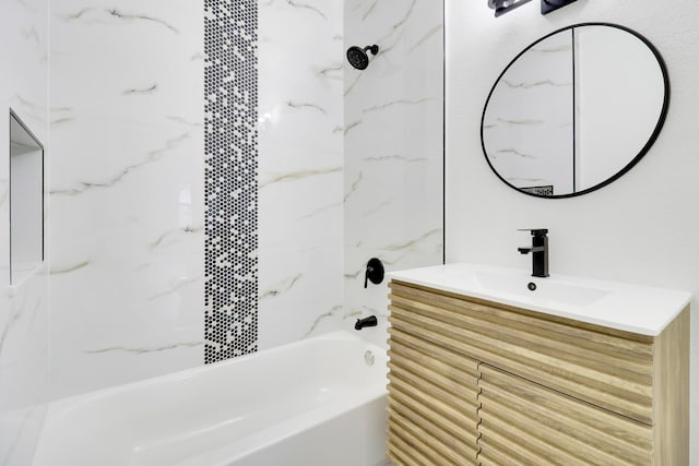 bathroom with vanity and tiled shower / bath