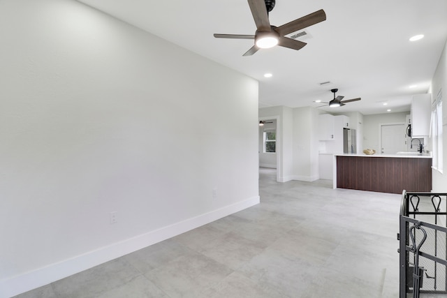 interior space featuring ceiling fan and sink