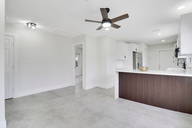 kitchen featuring white cabinets, kitchen peninsula, sink, and stainless steel refrigerator with ice dispenser