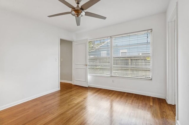 spare room with hardwood / wood-style floors and ceiling fan