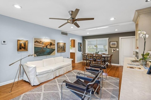 living room with ceiling fan and hardwood / wood-style floors