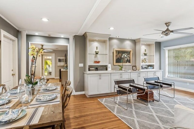 dining space featuring ceiling fan, light wood-type flooring, and sink