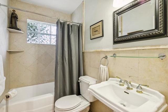 full bathroom featuring sink, shower / bath combo, tile walls, and toilet