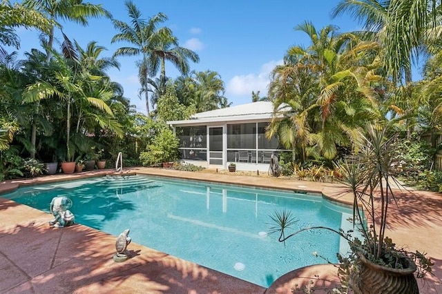 view of pool featuring a sunroom